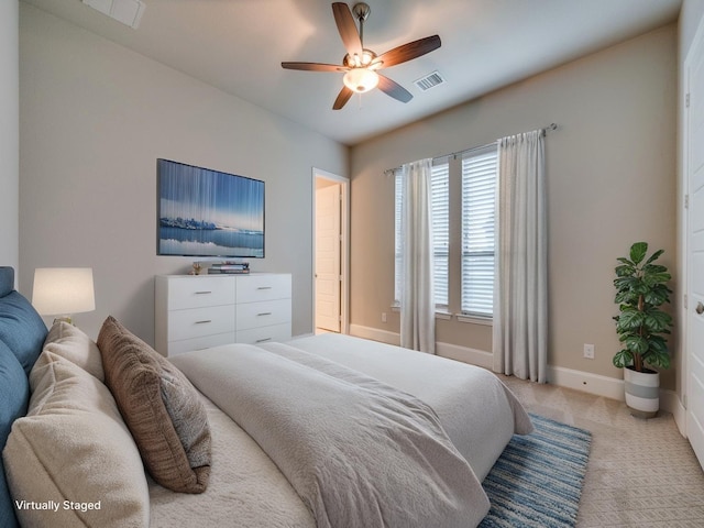 bedroom with visible vents, baseboards, ceiling fan, and light carpet