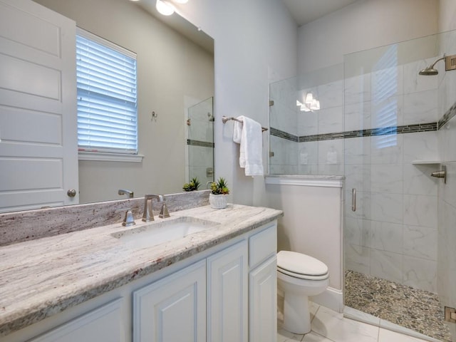 bathroom featuring toilet, a shower stall, marble finish floor, and vanity