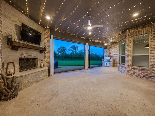 unfurnished living room featuring brick wall and an outdoor stone fireplace