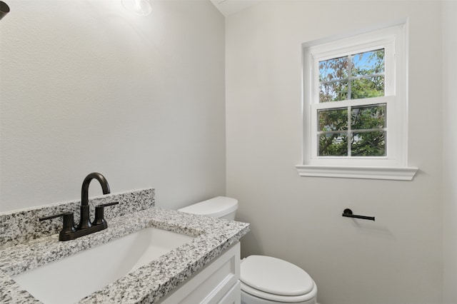 bathroom with toilet and vanity