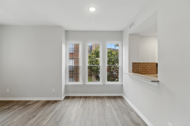unfurnished room featuring visible vents, baseboards, recessed lighting, and light wood-style floors