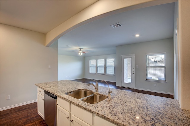 kitchen featuring a sink, open floor plan, visible vents, light stone counters, and dishwasher