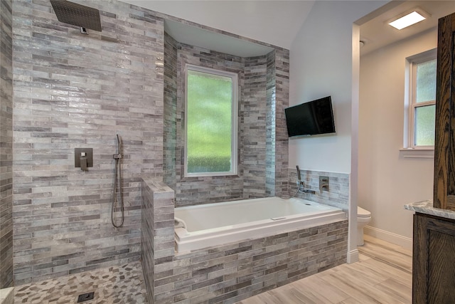 full bath with tiled shower, baseboards, a garden tub, and toilet