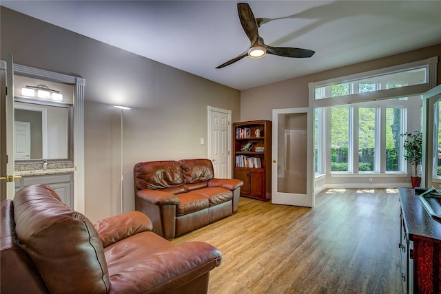 living room with ceiling fan and light wood-style floors