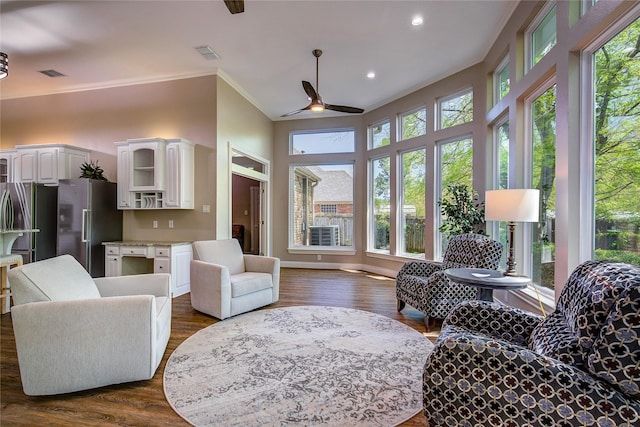 living area featuring visible vents, ceiling fan, crown molding, recessed lighting, and dark wood-type flooring