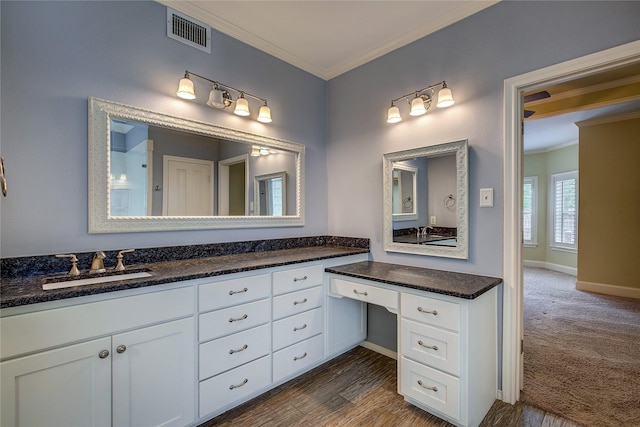 full bathroom with baseboards, ornamental molding, vanity, and visible vents