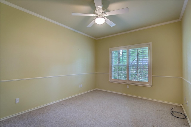 carpeted empty room with a ceiling fan, baseboards, and ornamental molding