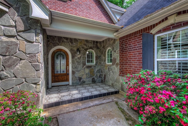 entrance to property with stone siding and brick siding