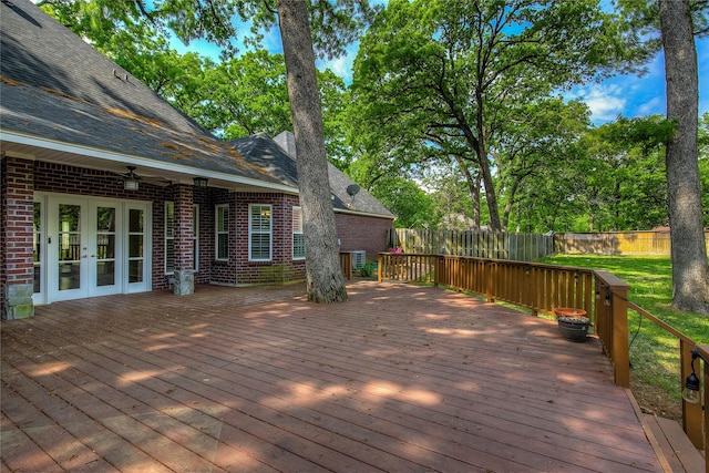 wooden terrace with french doors and a fenced backyard