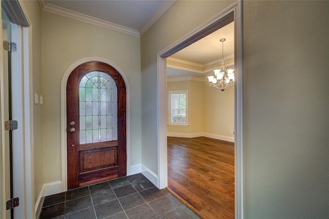 entrance foyer featuring arched walkways, a wealth of natural light, ornamental molding, and a notable chandelier