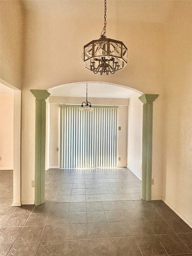 2505 Montclair Ln, Mesquite, TX 75150 - spare room with decorative columns, baseboards, a notable chandelier, and arched walkways