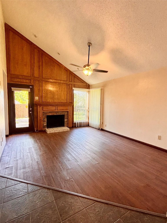2505 Montclair Ln, Mesquite, TX 75150 - unfurnished living room featuring dark wood-style floors, a fireplace, a textured ceiling, and lofted ceiling