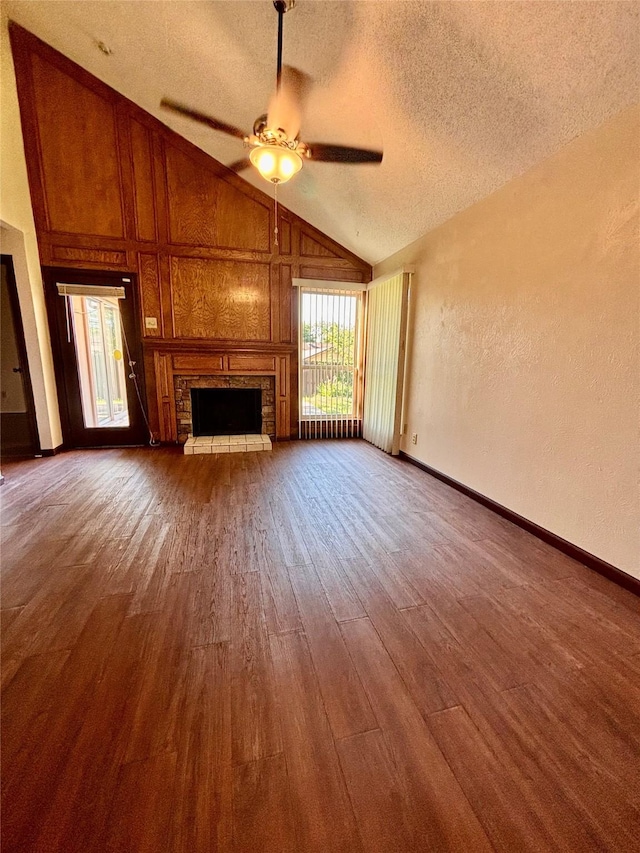 2505 Montclair Ln, Mesquite, TX 75150 - unfurnished living room featuring a textured ceiling, ceiling fan, a textured wall, a fireplace, and wood finished floors