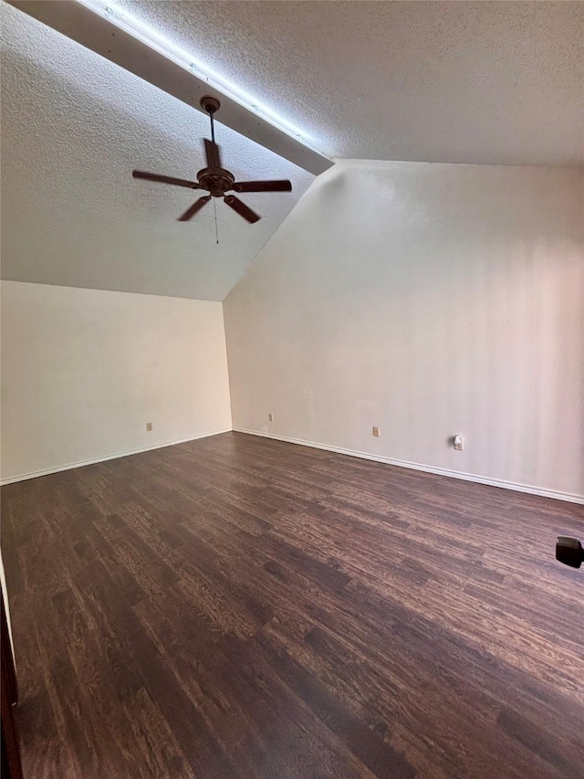 2505 Montclair Ln, Mesquite, TX 75150 - interior space featuring a textured ceiling, baseboards, vaulted ceiling, dark wood-type flooring, and a ceiling fan