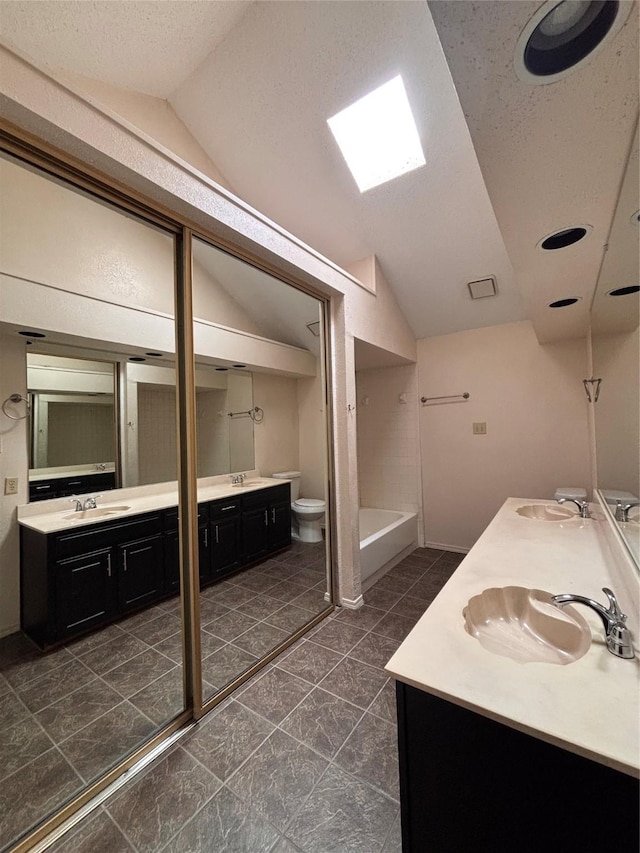 2505 Montclair Ln, Mesquite, TX 75150 - full bath with a sink, double vanity, and vaulted ceiling