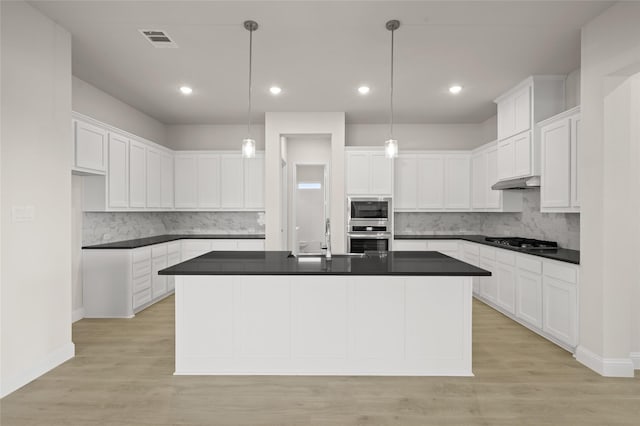 2413 Rams Horn, Waxahachie, TX 75167 - kitchen with appliances with stainless steel finishes, visible vents, dark countertops, and a sink