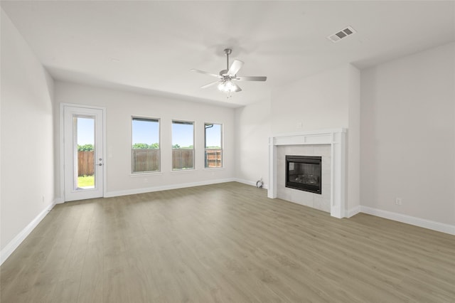 2413 Rams Horn, Waxahachie, TX 75167 - unfurnished living room with a fireplace, light wood-style floors, ceiling fan, visible vents, and baseboards