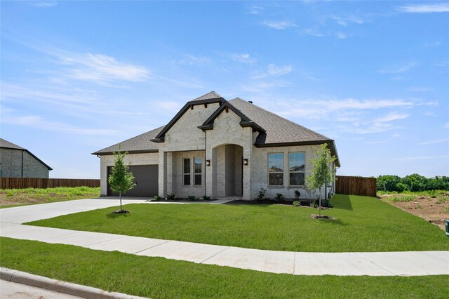 2413 Rams Horn, Waxahachie, TX 75167 - french country inspired facade with a garage, fence, a front lawn, and driveway
