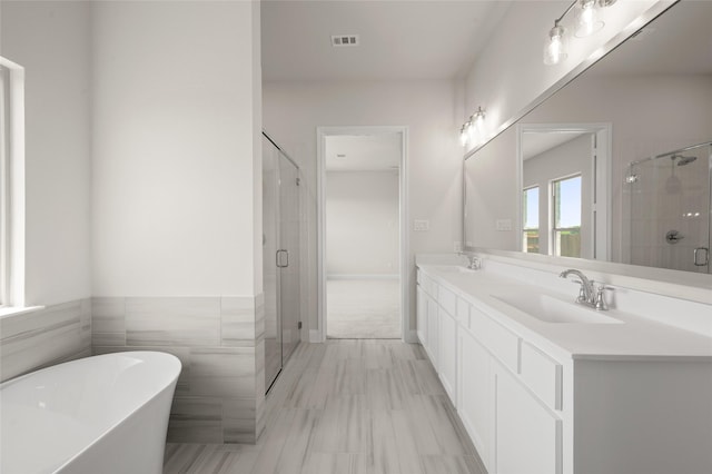 2413 Rams Horn, Waxahachie, TX 75167 - bathroom with a stall shower, a sink, a soaking tub, and visible vents