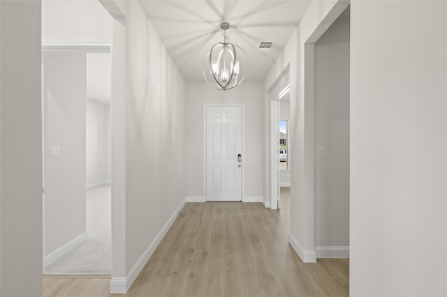 2413 Rams Horn, Waxahachie, TX 75167 - corridor with baseboards, visible vents, a notable chandelier, and light wood-style floors