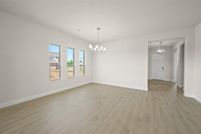 2413 Rams Horn, Waxahachie, TX 75167 - unfurnished room featuring visible vents, light wood-style flooring, a chandelier, and baseboards