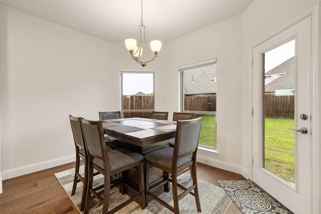 14662 Gentle Breeze Rd, Frisco, TX 75035 - dining area featuring baseboards, plenty of natural light, an inviting chandelier, and wood finished floors