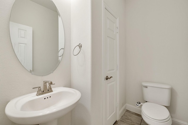 14662 Gentle Breeze Rd, Frisco, TX 75035 - half bathroom with a sink, toilet, and baseboards