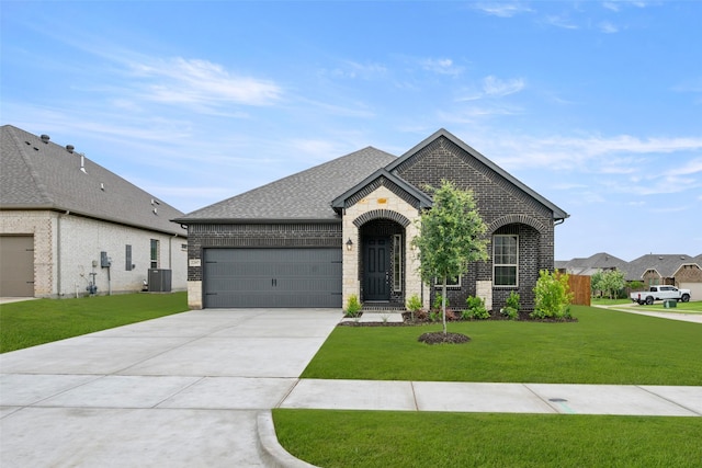 2297 High Plain Ln, Waxahachie, TX 75167 - french provincial home with brick siding, cooling unit, an attached garage, driveway, and a front yard