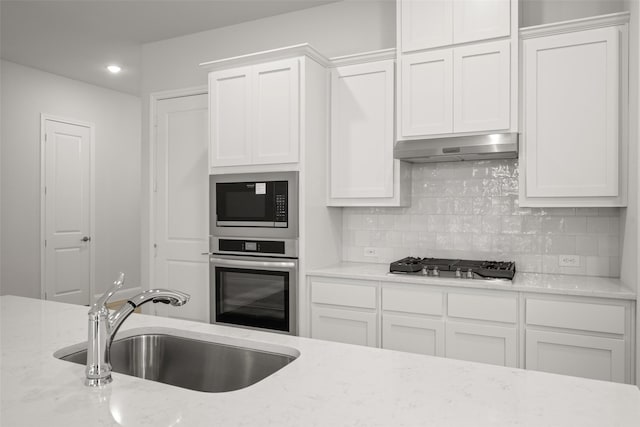 2297 High Plain Ln, Waxahachie, TX 75167 - kitchen featuring appliances with stainless steel finishes, ventilation hood, a sink, white cabinetry, and recessed lighting