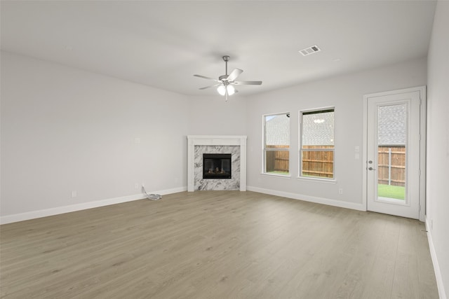 2297 High Plain Ln, Waxahachie, TX 75167 - unfurnished living room featuring ceiling fan, a premium fireplace, wood finished floors, and baseboards