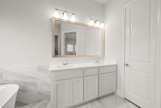 2297 High Plain Ln, Waxahachie, TX 75167 - bathroom with double vanity, marble look tiles, and a soaking tub