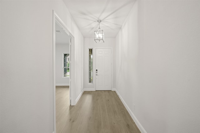 2297 High Plain Ln, Waxahachie, TX 75167 - entryway with light wood-style flooring, baseboards, and a chandelier