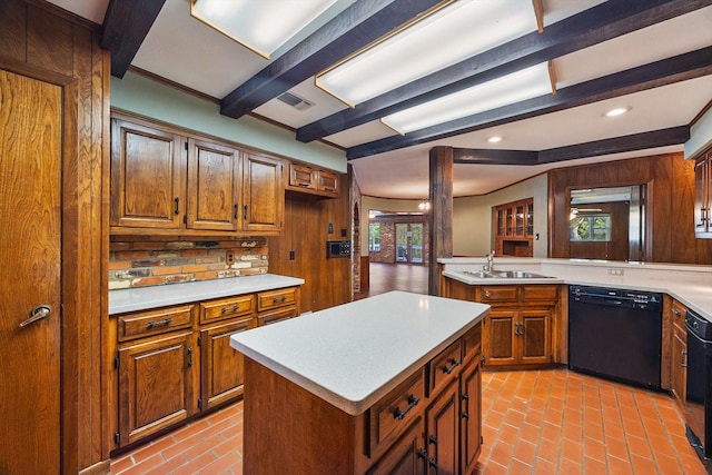 kitchen featuring light countertops, a sink, and black dishwasher