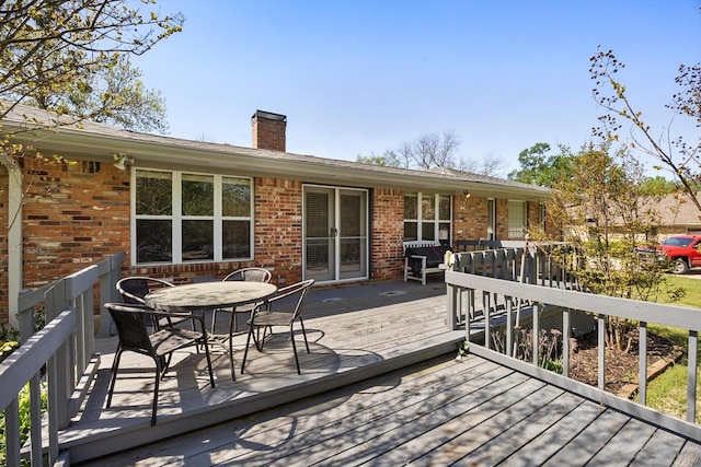 wooden deck with outdoor dining area