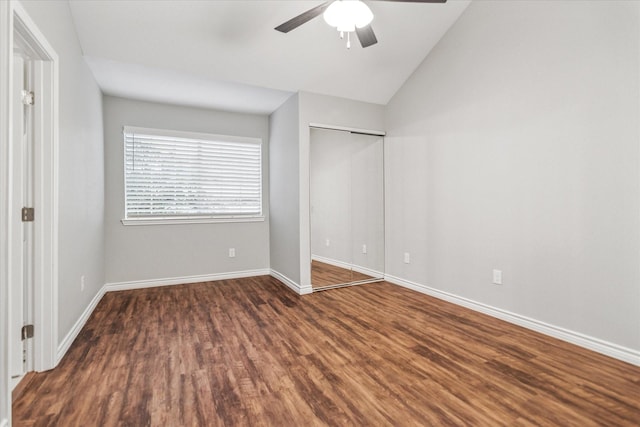unfurnished bedroom with wood finished floors, lofted ceiling, baseboards, ceiling fan, and a closet
