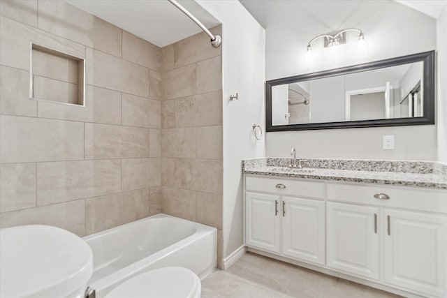 bathroom featuring toilet, shower / bath combination, and vanity