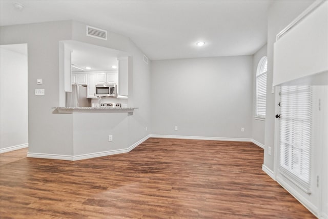 unfurnished living room featuring wood finished floors, baseboards, and recessed lighting