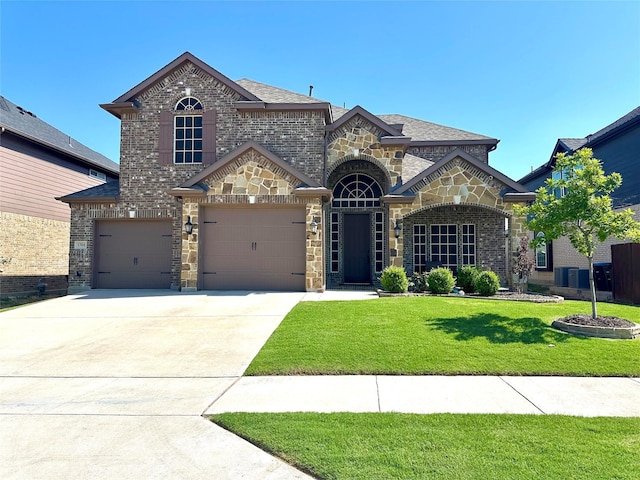 1304 Needle Cactus Dr, Fort Worth, TX 76177 - french country home with driveway, a front yard, stone siding, and brick siding