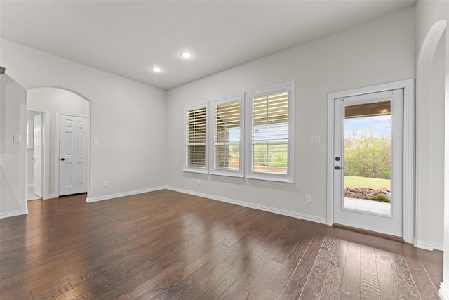 109 Joplin Dr, Mckinney, TX 75071 - unfurnished living room with arched walkways, dark wood-style flooring, baseboards, and recessed lighting
