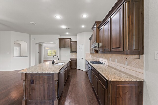 109 Joplin Dr, Mckinney, TX 75071 - kitchen featuring dark wood-style flooring, under cabinet range hood, arched walkways, dishwasher, and a sink