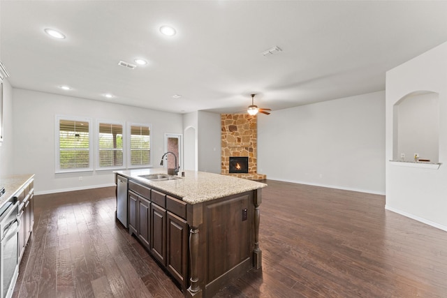 109 Joplin Dr, Mckinney, TX 75071 - kitchen with a stone fireplace, visible vents, dark wood finished floors, a sink, and ceiling fan