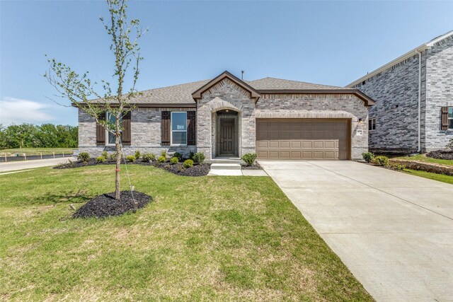 4050 Bedford Dr, Crandall, TX 75114 - french country inspired facade featuring brick siding, an attached garage, a front yard, and driveway