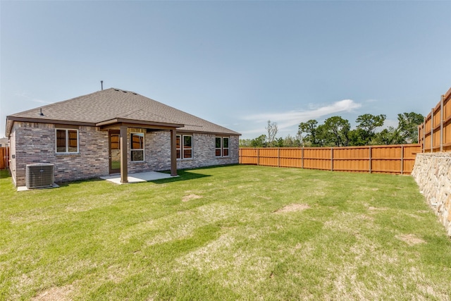 4050 Bedford Dr, Crandall, TX 75114 - rear view of property featuring a lawn, a shingled roof, a fenced backyard, a patio, and cooling unit