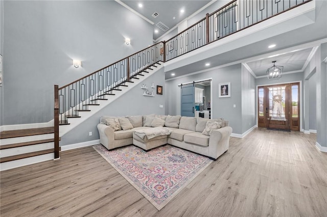 10281 Creekside Ln, Waco, TX 76712 - living area with stairs, ornamental molding, baseboards, wood finished floors, and a towering ceiling