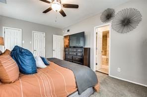 bedroom with baseboards, a ceiling fan, two closets, connected bathroom, and carpet