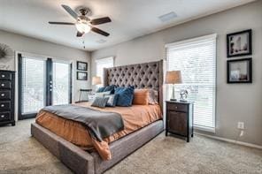 carpeted bedroom featuring baseboards, access to outside, and ceiling fan