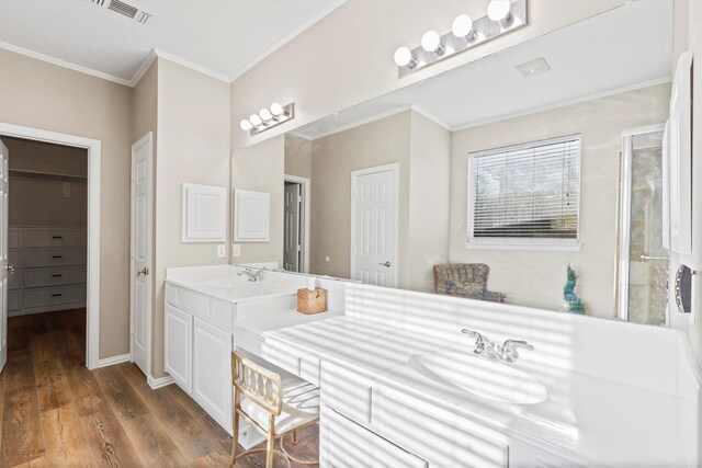 110 Harvest Bend Dr, Wylie, TX 75098 - bathroom with wood finished floors, crown molding, a shower stall, double vanity, and baseboards