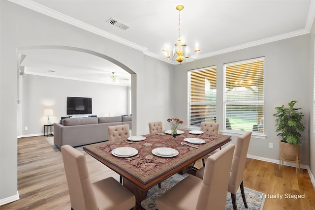 110 Harvest Bend Dr, Wylie, TX 75098 - dining area with a chandelier, crown molding, arched walkways, light wood-type flooring, and baseboards