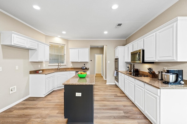 110 Harvest Bend Dr, Wylie, TX 75098 - kitchen featuring a sink, stainless steel appliances, crown molding, a center island, and white cabinets