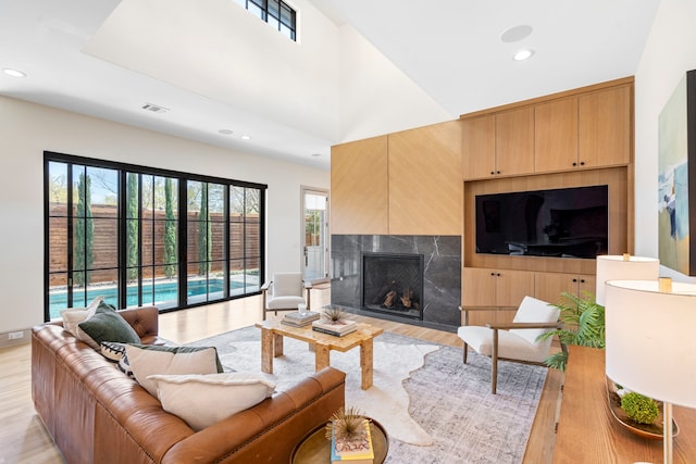 7158 Pasadena Ave, Dallas, TX 75214 - living room featuring light wood-type flooring, a fireplace, baseboards, and recessed lighting